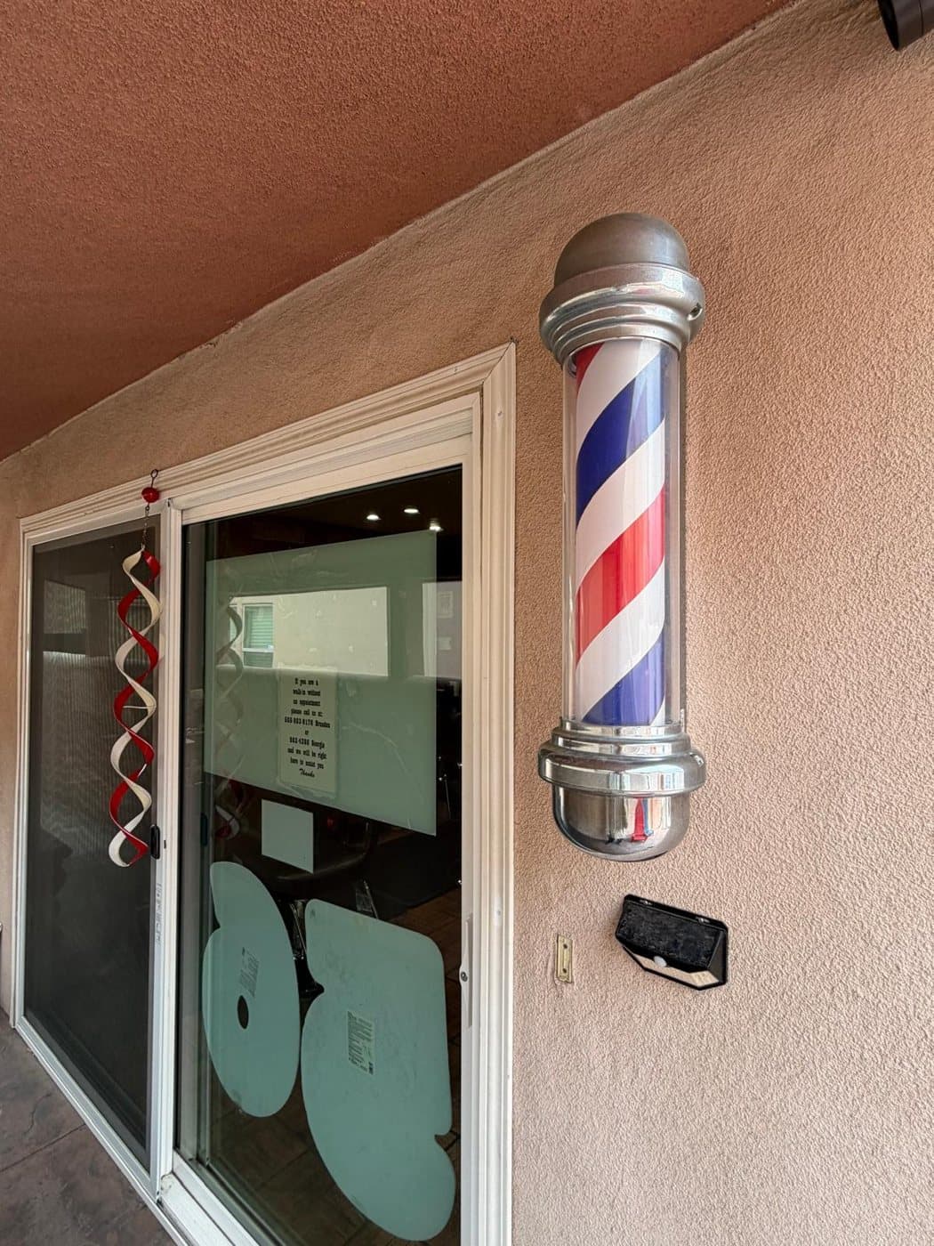 The patio-door entrance with a lit barber pole