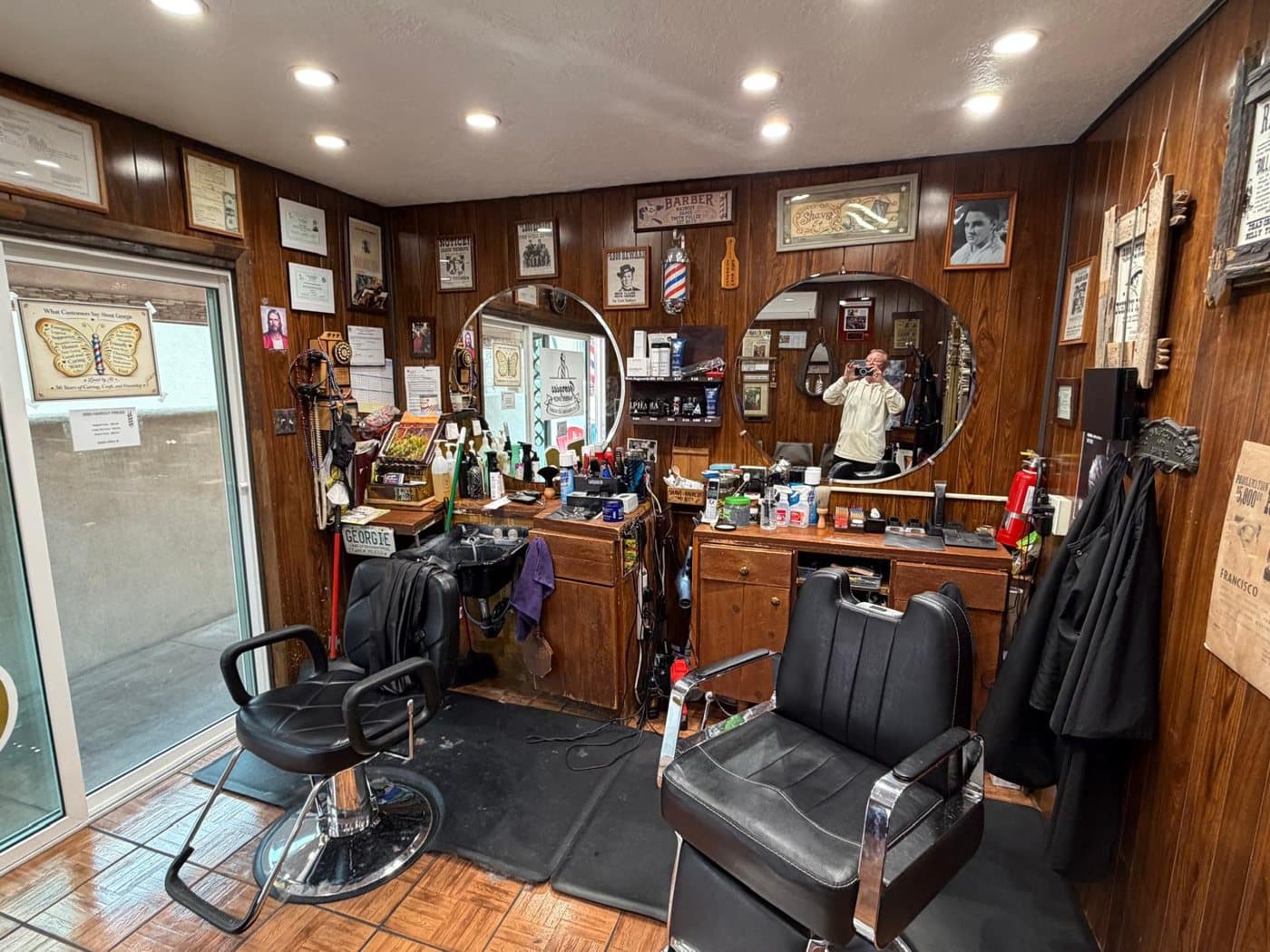 Inside Georgie’s: two classic barber chairs, wood panelling and a wall of memories