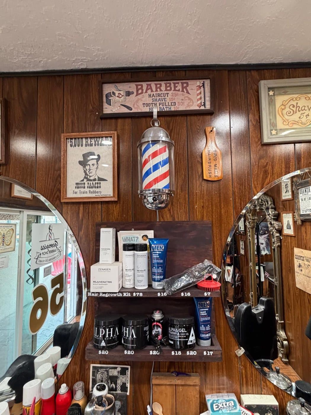Barber pole, mirrors and products on the shop wall